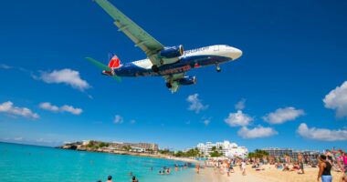 The eerie Caribbean beach where planes fly right above your head - but tourists still call it a tropical paradise