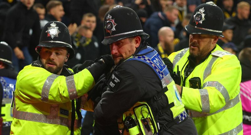 The shocking moment police officers are punched in the face at Aston Villa: New footage shows Swiss hooligans' disgraceful behaviour as violence returns to English football