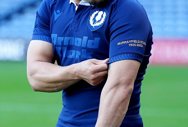Scotland skipper Sione Tuipulotu shows off his country's commemorative jersey for the Murrayfield Test against the All Blacks