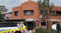 Three men are fighting for their lives after they were hit by a car that crashed and mounted the curb outside an Indian restaurant in Sydney's west.