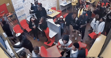 gif of rowdy crowd causing a fight inside a domino
