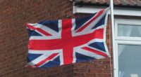 Adam Peaty's family fly Union Flag upside down as they stay miles away