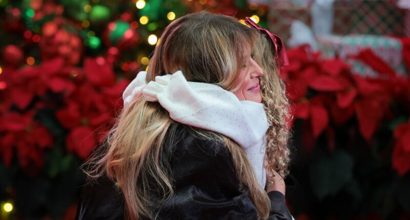 Adorable moment Melania hugs five-year-old patient as she celebrates Christmas at children's hospital