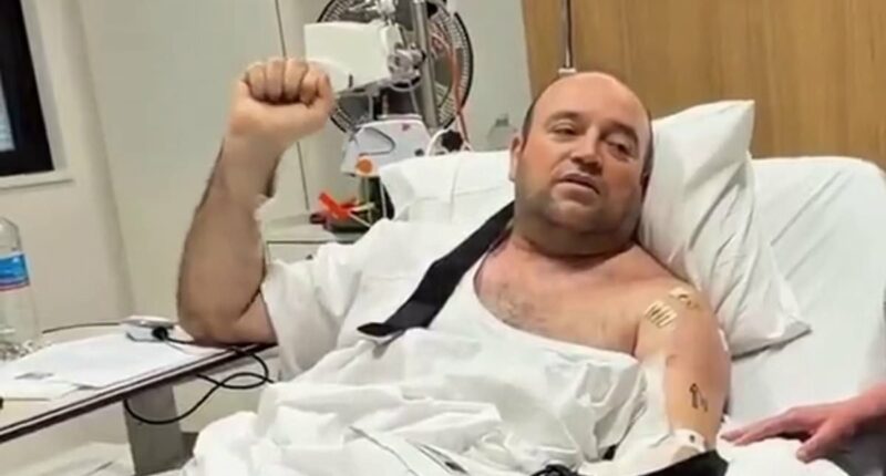 Bondi hero is handed $2.5million cheque in his hospital bed