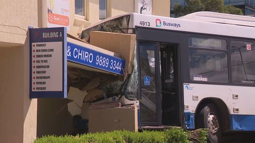 A bus has crashed into the side of a medical centre after a collision with a car in Sydney's north-west.