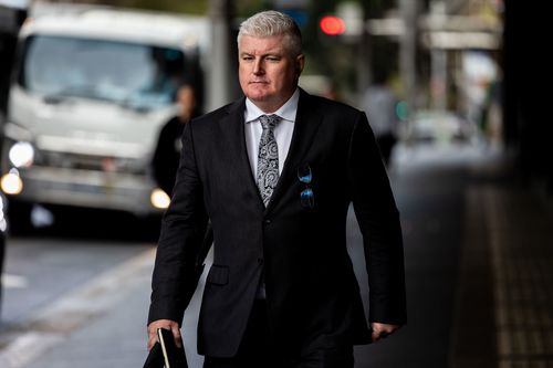 Former Australian cricketer Stuart MacGill arrives at Downing Centre Local court, Friday, 9 May 2025.    Macgill, an Australian cricketing great  will this morning learn whether he will be jailed after being found guilty by a District Court jury of helping to set up, and being present at, a meeting between the man and a street-level drug dealer, who can only be known as Person A, underneath his Neutral Bay restaurant in April 2021.   Photo: Sam Mooy / The Sydney Morning Herald