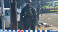 Heavily-armed police storm a street in Sydney in mystery operation