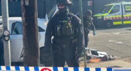 Heavily-armed police storm a street in Sydney in mystery operation