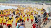 Surf Life savers from Bondi fill the beach after a minutes silence on Saturday, before starting patrol.