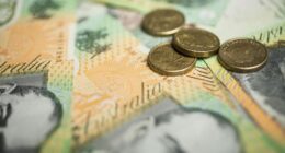 A generic picture of Australian money - $2 coins on top of $100 notes.