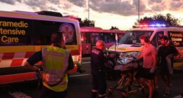 A person is transported to an ambulance in North Bondi following a shooting incident.