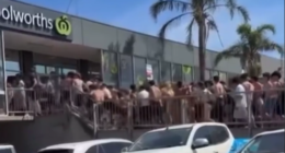 Vision shows hundreds of young beachgoers storming the Woolworths store.