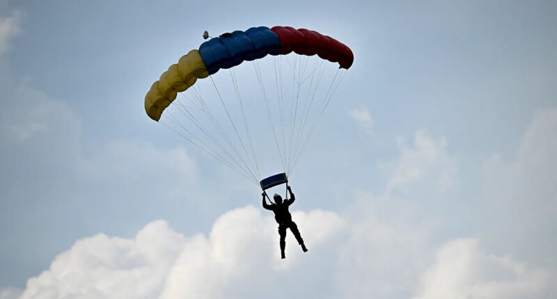 Skydiver survives after reserve parachute accidentally deploys, leaving him dangling from flying airplane