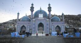 Afghans walk outside Hazara's Sakhi Shrine in Kabul, Afghanistan, Friday, April 19, 2024.