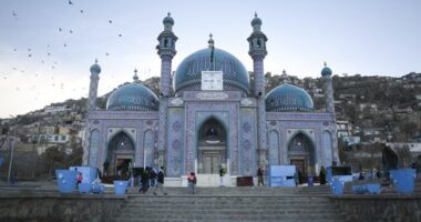 Afghans walk outside Hazara's Sakhi Shrine in Kabul, Afghanistan, Friday, April 19, 2024.