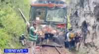Videos on local media showed train cars with broken windows and dented sides stuck along a rail line hemmed in between a lush forest and a massive rock.