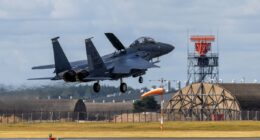 White-knuckle moment police helicopter flies close to US fighter jet