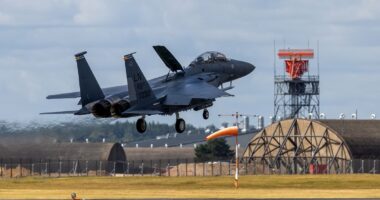 White-knuckle moment police helicopter flies close to US fighter jet