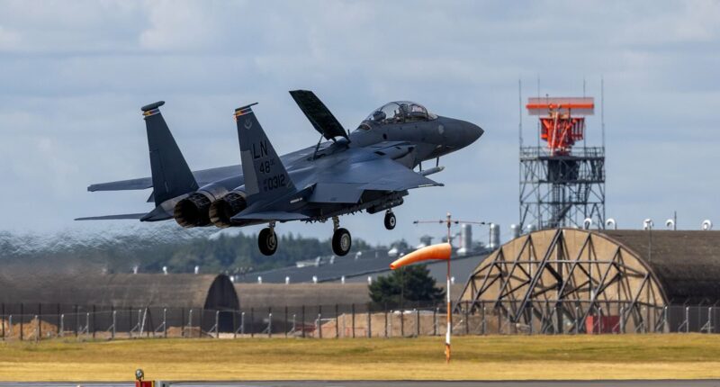 White-knuckle moment police helicopter flies close to US fighter jet