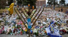 SYDNEY, AUSTRALIA - DECEMBER 21: General view of the memorial at Bondi Pavilion on December 21, 2025 in Sydney, Australia. Life slowly returned to normal at Bondi Beach, with people from all walks of life still paying respects and tributes as raw grief and funerals gave way to quiet commemorations. Police say at least 16 people, including one suspected gunman, were killed and more than 40 others injured when two attackers opened fire near a Hanukkah celebration at the world-famous Bondi Beach, i