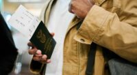 Close-up of male traveler on a vacation holding his passport and boarding pass at airport