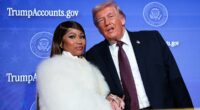 Careful she doesn't cut you, Donald! Nicki Minaj flashes dagger-long nails as she clutches Trump's hand after gushing she's his No. 1 fan