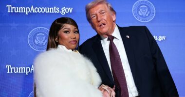 Careful she doesn't cut you, Donald! Nicki Minaj flashes dagger-long nails as she clutches Trump's hand after gushing she's his No. 1 fan