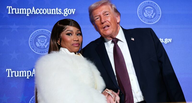Careful she doesn't cut you, Donald! Nicki Minaj flashes dagger-long nails as she clutches Trump's hand after gushing she's his No. 1 fan