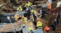 A woman who warned others of a landslide just moments before she was buried in rubble is being hailed a hero as desperate search efforts continue. Multiple children are among those unaccounted for after a big landslide destroyed the popular Mount Maunganui Beachside Holiday Park on New Zealand's North Island. The woman is being praised by locals after she frantically pulled campers from their beds at 5am and warned them of danger so they could start packing up to leave. In a tragic twist, the same woman later became trapped in a toilet block along with several others when the hillside completely collapsed a few hours later, at about 9.30am on Thursday. The amenities block was buried in the landslip, with rescuers hearing terrified screams for help, but being unable to hear further cries after about 15 minutes. 'I just want you to know that one of the women that's in that shower block, she was a hero,' a witness, who didn't want to be named, told the New Zealand Herald. 'She went around at 5 o'clock this morning and she got us all out of bed and she woke us all up so that we could move out... and she's not out.'