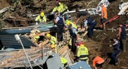 A woman who warned others of a landslide just moments before she was buried in rubble is being hailed a hero as desperate search efforts continue. Multiple children are among those unaccounted for after a big landslide destroyed the popular Mount Maunganui Beachside Holiday Park on New Zealand's North Island. The woman is being praised by locals after she frantically pulled campers from their beds at 5am and warned them of danger so they could start packing up to leave. In a tragic twist, the same woman later became trapped in a toilet block along with several others when the hillside completely collapsed a few hours later, at about 9.30am on Thursday. The amenities block was buried in the landslip, with rescuers hearing terrified screams for help, but being unable to hear further cries after about 15 minutes. 'I just want you to know that one of the women that's in that shower block, she was a hero,' a witness, who didn't want to be named, told the New Zealand Herald. 'She went around at 5 o'clock this morning and she got us all out of bed and she woke us all up so that we could move out... and she's not out.'