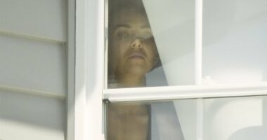 Cops are seen visiting Tess Crosley's home as former Mormon missionary is spotted peering anxiously out the window amid Lachie Neale scandal