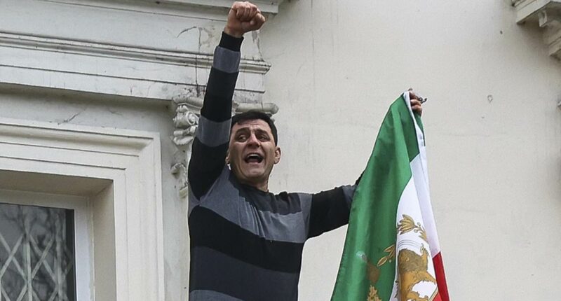 Dissidents remove Iranian flag from embassy as thousands protest in UK