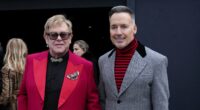 Elton John is aided by David Furnish as he heads to Valentino's show