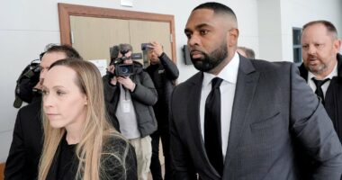 Ex-Michigan coach Moore is joined by loyal wife for court appearance