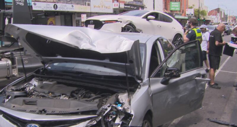Man restrained by passersby after car crashes into multiple others on busy road