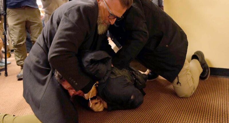 Man who squirted vinegar on politician is charged with assaulting and intimidating her