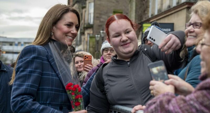 Moment Kate sprints past her security to greet a fan with flowers
