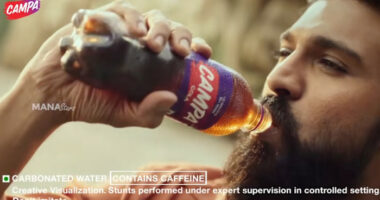 A still of a Campa Cola advertisement depicting a bearded Bollywood actor drinking a bottle of Campa Cola