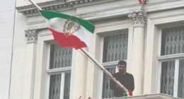 Protester scales Iranian Embassy in London, tears down regime flag, hoists pre-revolution symbol