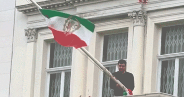 Protester scales Iranian Embassy in London, tears down regime flag, hoists pre-revolution symbol