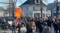 Protesters burn flag after woman shot dead by ICE in Minneapolis