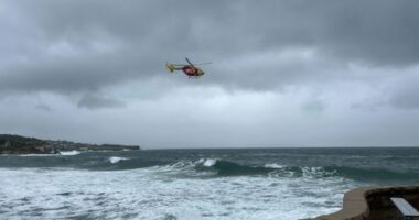 Searches resume for two people missing at NSW beaches after spate of drownings