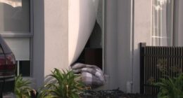 A doona was seen hanging out of the smashed window of the Altona North townhouse.