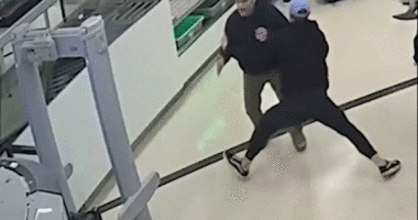 gif of bystander tackling man at airport
