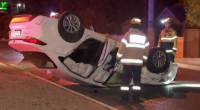 CCTV shows Adelaide carjacker walk away from crash after flipping car on roundabout