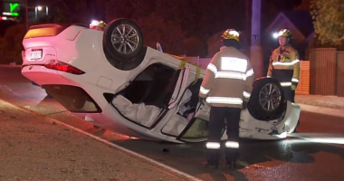 CCTV shows Adelaide carjacker walk away from crash after flipping car on roundabout