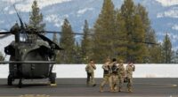U.S. Army soldiers exit a Black Hawk at the Truckee Tahoe Airport in Truckee, Calif., Saturday, Feb. 21, 2026, after aiding in recovery efforts for a group of skiers who went missing during a deadly avalanche. (AP Photo/Godofredo A. VÃ¡squez)