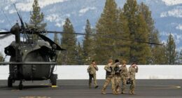 U.S. Army soldiers exit a Black Hawk at the Truckee Tahoe Airport in Truckee, Calif., Saturday, Feb. 21, 2026, after aiding in recovery efforts for a group of skiers who went missing during a deadly avalanche. (AP Photo/Godofredo A. VÃ¡squez)