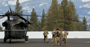 U.S. Army soldiers exit a Black Hawk at the Truckee Tahoe Airport in Truckee, Calif., Saturday, Feb. 21, 2026, after aiding in recovery efforts for a group of skiers who went missing during a deadly avalanche. (AP Photo/Godofredo A. VÃ¡squez)
