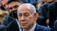 Israel's Prime Minister Benjamin Netanyahu reacts during the funeral of Israeli hostage Ran Gvili, whose remains were brought back to Israel, in the southern town of Meitar on Wednesday, Jan. 28, 2026.(Chaim Goldberg/Pool Photo via AP)
